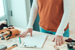© Bits and Splits - Female carpenter with hands on the desk