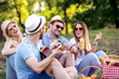 © ivanko80 - Group of friends on picnic in park