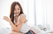 © paulaphoto - Portrait of beauty  smiling asian woman applying a lotion to her arm skin during her morning routine. Skincare body lotion, beauty clinic skincare spa indoors lifestyle concept