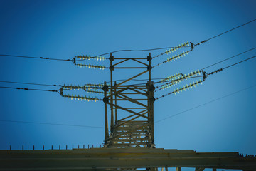 Electric pole with wires of high voltage against the sky.