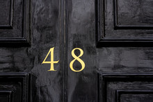 Shiny House Door With The Number 48 With The Forty-eight In Bronze Paint