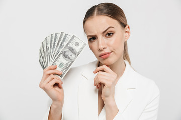 Wall Mural - Photo of modern businesswoman 20s wearing elegant jacket holding fan with dollar money banknotes