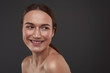 © Yakobchuk Olena - Joyful pretty girl with natural makeup standing against gray background