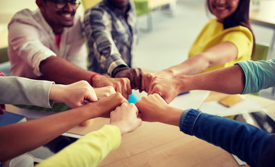 Poster - education, school, teamwork and people concept - close up of international students hands making fist bump gesture