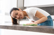 © Drobot Dean - Portrait of beautiful asian girl cleaning table with detergent and rag in kitchen at home
