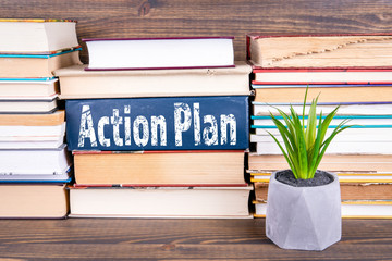 Wall Mural - Action Plan concept. Books stacked on a wooden table