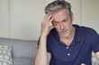 © goodluz - Mature man with bad headache at home