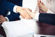 © rogerphoto - Business people shaking hands finishing up a meeting. Handshake at successful negotiation