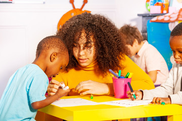 Wall Mural - Draw lesson for small little black boy in school