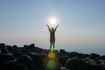 Woman on cliff of mountains.