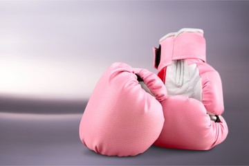 Wall Mural - Pink boxing gloves on grey background