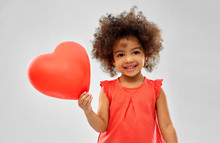 Childhood And People Concept - Happy Little African American Girl With Red Heart Shaped Balloon Over Grey Background