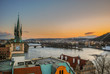 Clock tower looking out over the Vltava River in Prague at sunset.