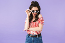 Portrait Of Flirting Pin-up Woman 20s In American Style Wear Holding Retro Sunglasses And Smiling At Camera