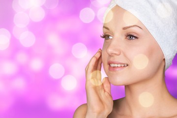 Poster - Portrait of beautiful young woman  in white towel on head on background