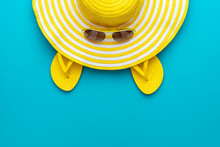 Top View Of Yellow Sunglasses, Striped Retro Hat And Flip-flops