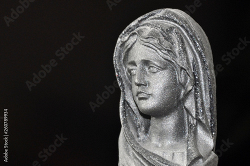 Fotomural Holy Virgin Mary in the rays of sunlight on a black background
