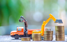 The Yellow Truck Toy Behind Coins Stack Save The Money Invest For The Future Concept Business, Financial, Tax And Bonus. Logistics And Transportation Concept.