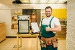 © Nomad_Soul - Worker holds repair checklist against refrigerator