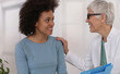 Mature Doctor comforting young Woman Patient. Professional medical help,support, advice Female health , gynecology concept