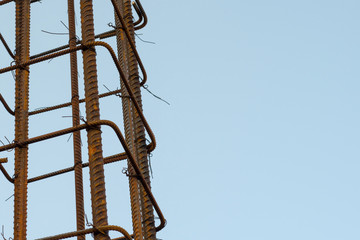 The iron base is wired to build a building against a background of blue sky with a place for your text.