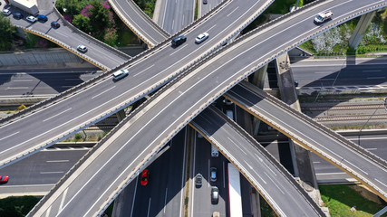 Aerial drone view of popular highway multilevel junction road, passing through National motorway in traffic jam