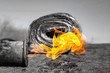 gas burner with fire and roll of roofing material on blurred background with bokeh effect