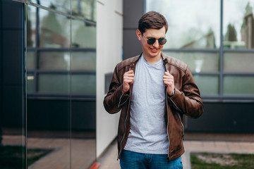 Wall Mural - A stylish man in a gray  T-shirt. Street photo