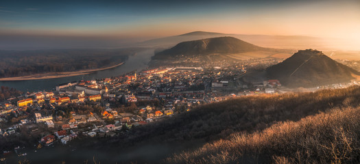 Canvas Print - View of a Small City near Danube River at Sunrise. Hainburg an der Donau, Austria seen from Hundsheimer Hill.