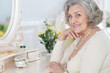 © aletia2011 - Close up portrait of happy senior woman sitting near dressing table
