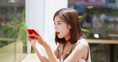 Canvas Print - Young woman play mobile game