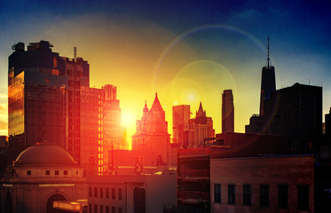 Wall Mural - New York City dramatic sunlight shines on the skyscrapers of the Manhattan skyline