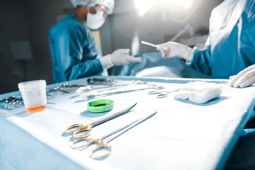 Wall Mural - selective focus of nurse giving medical equipment to surgeon in operating room