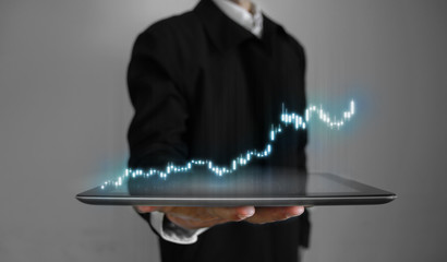 Poster - 3D rendering of annual business performance report stock candle stick charts glowing hologram hover over tablet in a palm of business man. Concept of virtual components presentation.