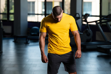 Wall Mural - Muscular Man Posing In Yellow T-shirt