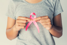 Womaen Hand Holding Pink Ribbon Breast Cancer Awareness. Concept Healthcare And Medicine