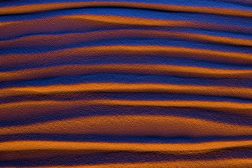 top view of abstract textured background with sand, smooth waves and color filter