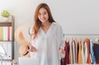 © bunditinay - Beautiful asian woman fashion designer standing in the clothing store and studio. In front of the camera to recording vlog video live streaming.Business online influencer on social media concept.