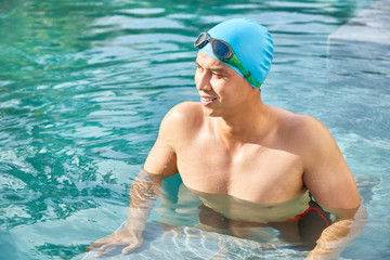 Young swimmer in the swimming pool