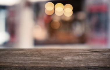 Empty dark wooden table in front of abstract blurred bokeh background of restaurant . can be used for display or montage your products.Mock up for space.