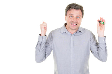 Excited man with keys to new home looking at camera