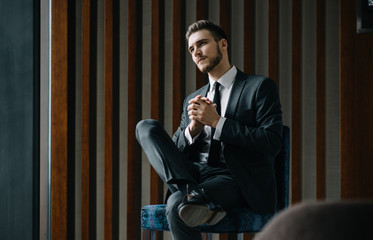 Wall Mural - Young businessman working on a plan of Internet project on the laptop. Man discusses business matters by phone. Working computer for internet research. Digital marketing. Development