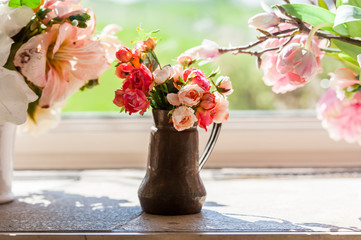 bouquet of flowers in a vase in front of window