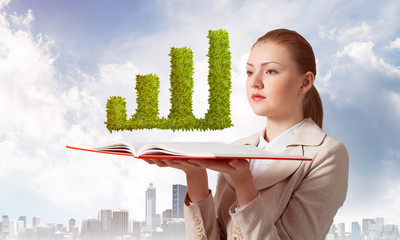 Woman with green plant shaped financial graph