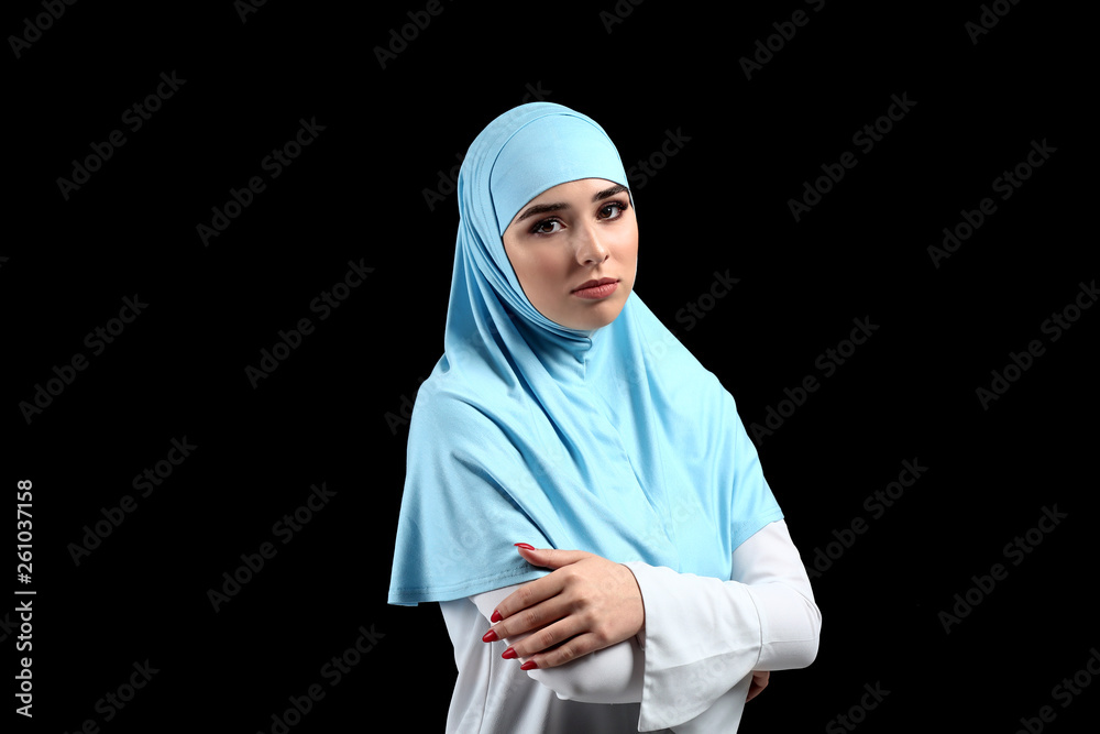Beautiful Muslim woman on dark background