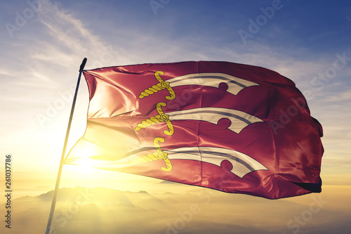 Cuadros en Lienzo Essex county of England flag waving on the top sunrise mist fog