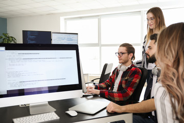 Team of programmers working in office