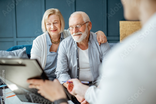 Fotomural Happy senior couple during the meeting with agent or financial consultant, signi