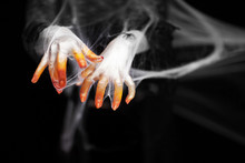 Creepy Halloween Hand In Orange And White With Spider Web, Zombie Hand On Black Background