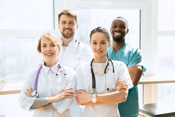 Healthcare people group. Professional male and female doctors posing at hospital office or clinic. Medical technology research institute and doctor staff service concept. Happy smiling models.